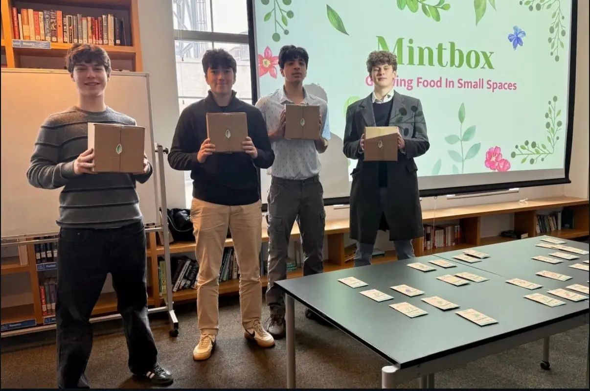 Three MintBox members presenting with laptops in hand.