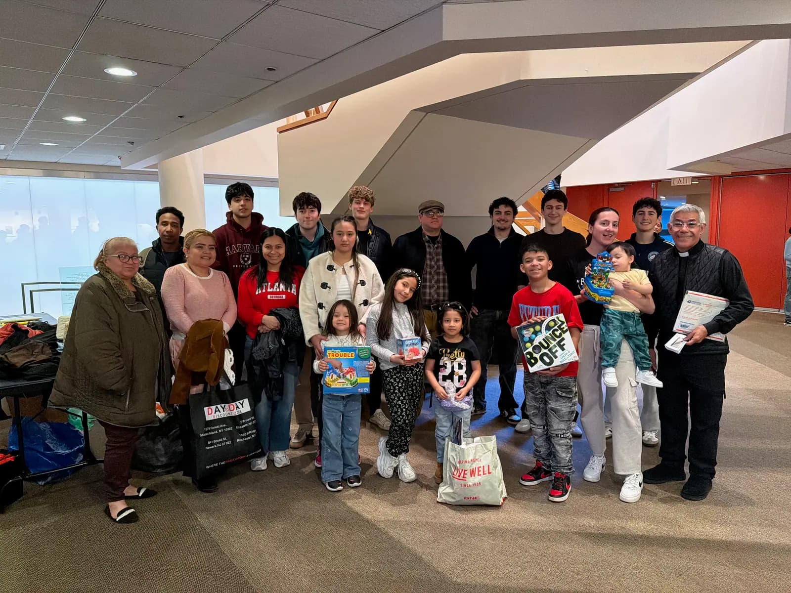 Volunteers, families and a clergy member gathered for a group photo at the end of the event.