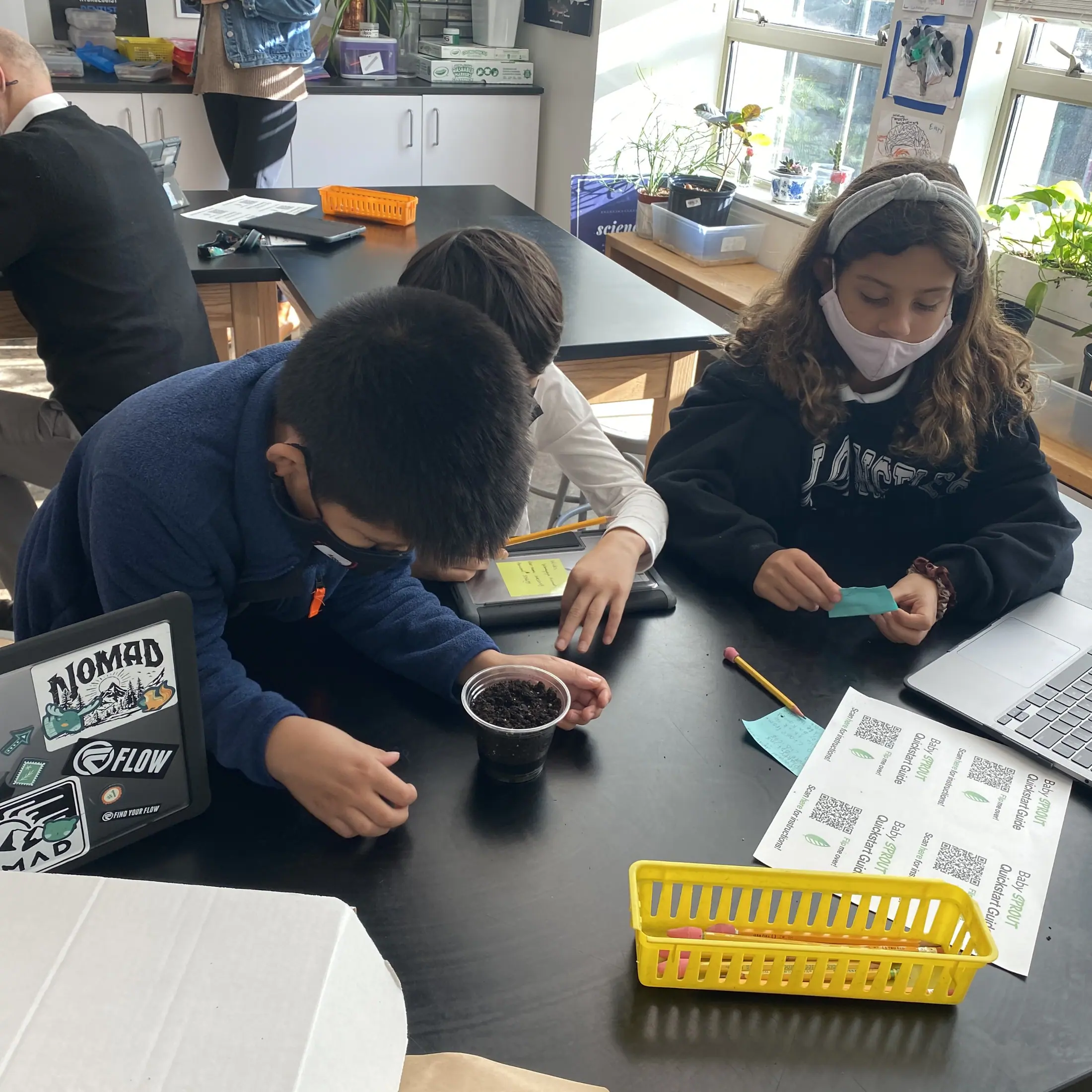 A Baby Sprout EDU kit set up on a classroom desk beside the printed curriculum.